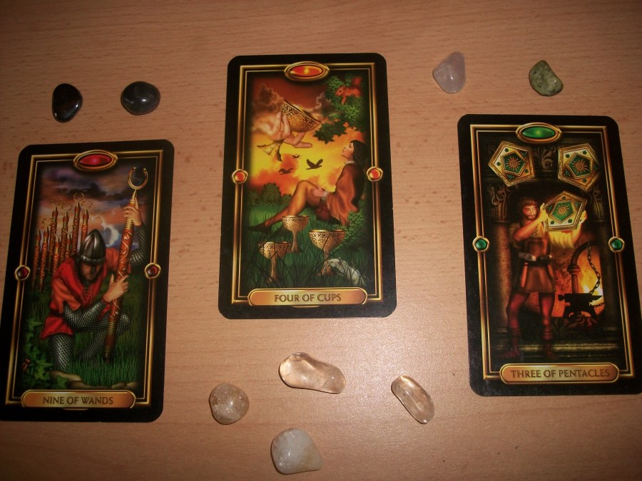 Photo of Gilded Tarot cards and crystal tumblestones. Tarot card reading with Gilded Tarot cards performed by professional Tarot reader Catherine Green of SpookyMrsGreen.com pagan lifestyle blog.