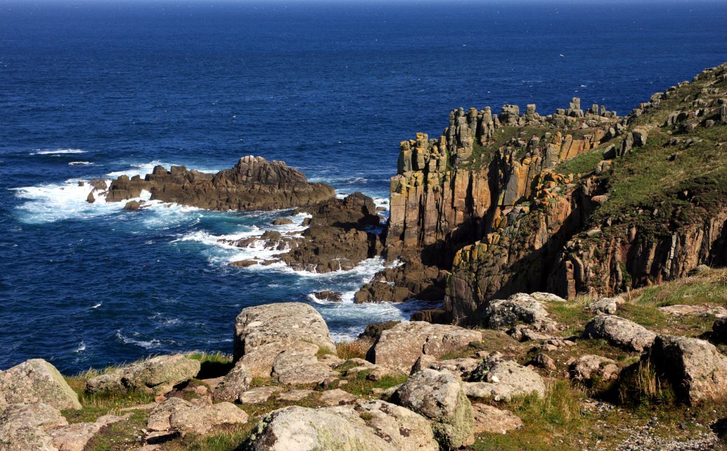 Choppy Sea and Jagged Rocks in Cornwall (Image credit unknown) inspiration for LGBT fantasy book series by Catherine Green of SpookyMrsGreen.com mindful parenting and modern pagan lifestyle blog.