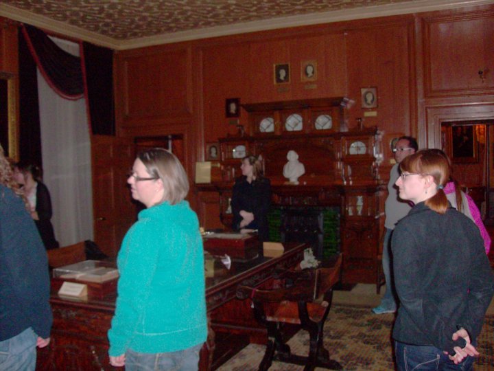 Photo of people inside a dark room in a period house. They are ghost hunters. Copyright Catherine Green of SpookyMrsGreen.com pagan lifestyle blog.