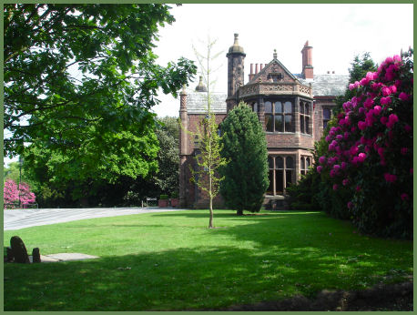 Image of a haunted house hidden behind trees. Ghost Hunter Diaries: Walton Hall in Warrington, Cheshire, UK at SpookyMrsGreen.com mindful parenting and modern pagan lifestyle blog.