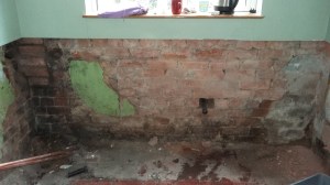 Image of bare brick walls in the small kitchen of a Victorian terraced house in UK. My Kitchen Renovation: Gutted and empty kitchen at SpookyMrsGreen.com mindful parenting and modern pagan lifestyle blog.