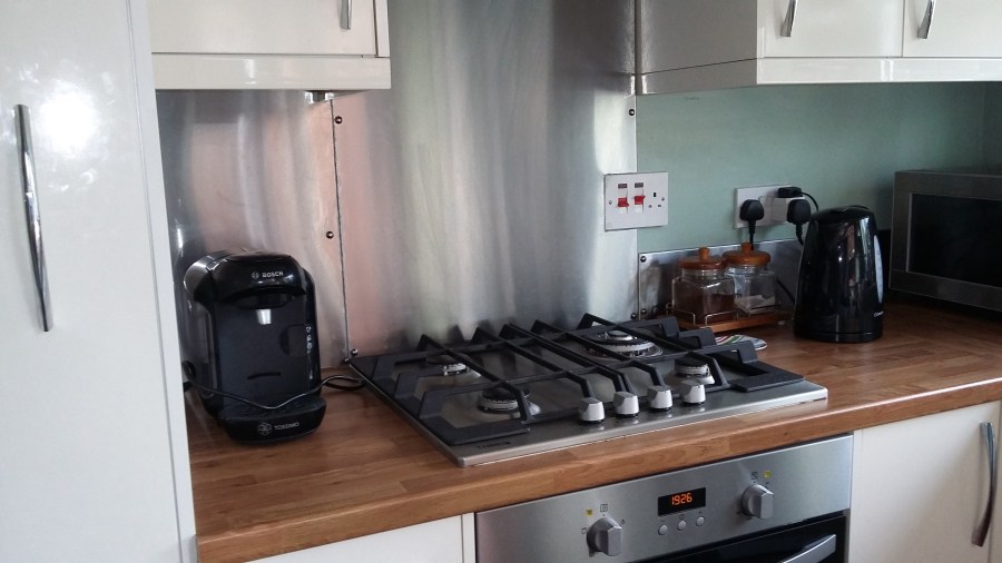 Image of white gloss fitted kitchen from Magnet, aluminium splashback, gas hob in a small kitchen of a Victorian terraced house in UK. #LookAgain My Kitchen Renovation at SpookyMrsGreen.com mindful parenting and modern pagan lifestyle blog.