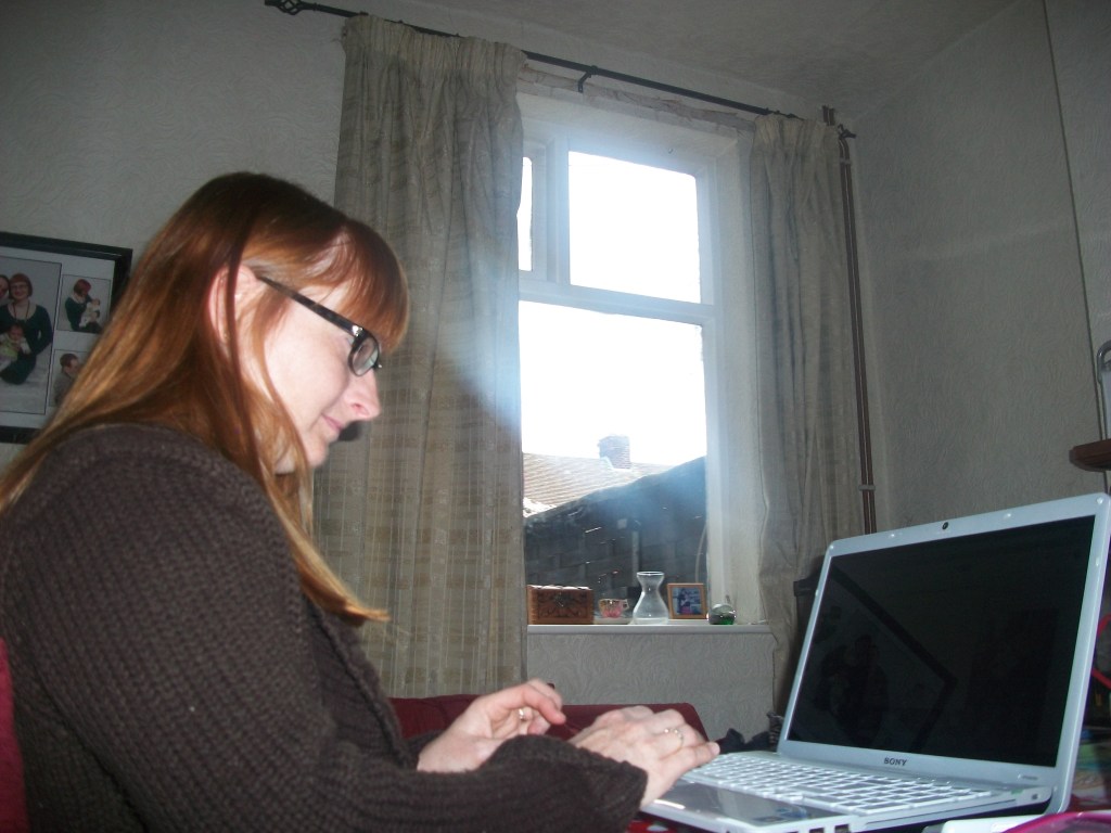 Vampire writer Catherine Green working on her laptop at SpookyMrsGreen.com mindful parenting and modern pagan lifestyle blog.