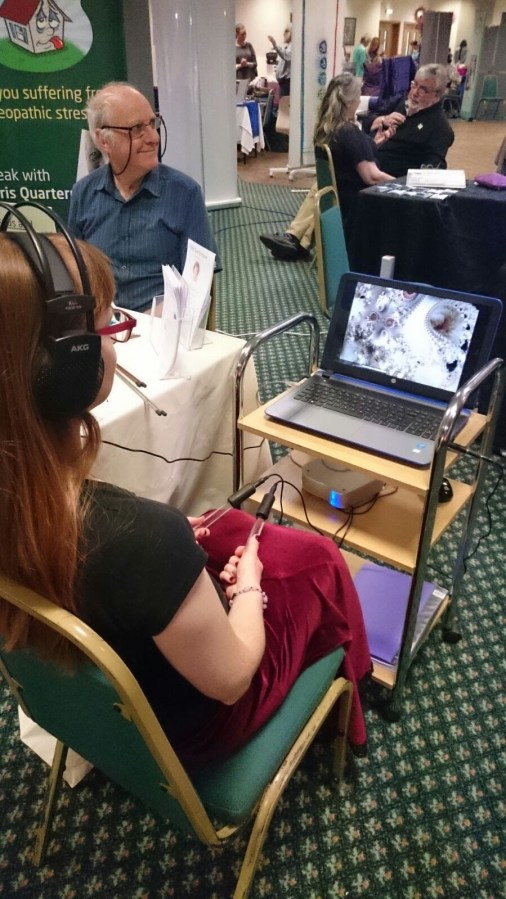 Catherine experiencing Trinfinity8 therapy with Chris Quartermaine at a Mind, Body, Spirit event. Supported by SpookyMrsGreen.com mindful parenting and modern pagan lifestyle blog.