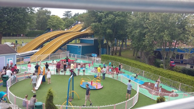 Image of families having fun in an outdoor water park in Britain. Peppa Pig Splash Zone at Paulton's Park on a beautiful summer's day. SpookyMrsGreen.com mindful parenting and modern pagan lifestyle blog.