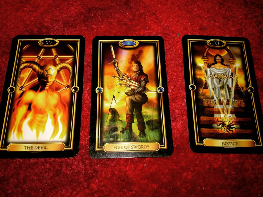 Image of Gilded Tarot cards on a red carpet. #365DaysofTarot April Retrograde Tarot reading with Gilded Tarot card deck owned by professional Tarot reader Catherine Green of SpookyMrsGreen.com pagan lifestyle blog.