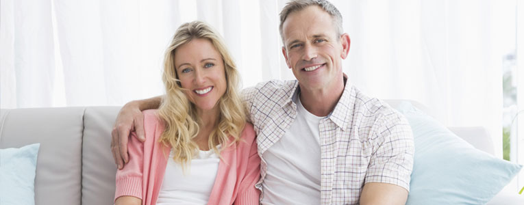 Image of an older man and woman sitting on a sofa together and smiling. Date Divorced Singles Sponsored Article by Catherine Green for SpookyMrsGreen.com mindful parenting and modern pagan lifestyle blog.