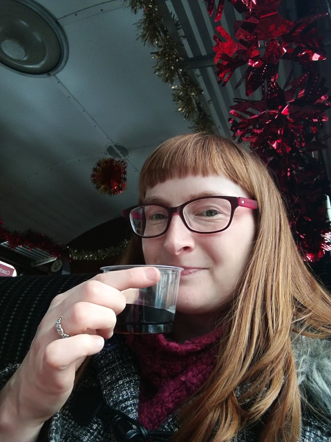 Drinking mulled wine on the Christmas train at SpookyMrsGreen.com mindful parenting and modern pagan lifestyle blog.