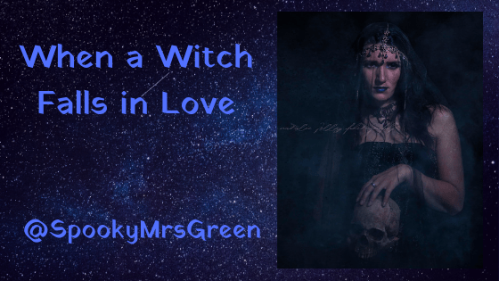 Image of a Gothic witch holding a skull and looking mysterious. Text reads "When a Witch Falls in Love @SpookyMrsGreen" - from the LGBT fantasy novel "Vampire of Blackpool" by Catherine Green
