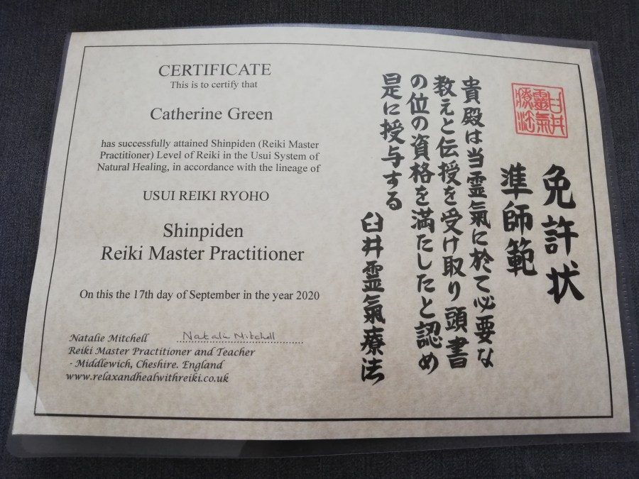 Photo of a certificate for Catherine Green qualifying as a Usui Reiki Ryoho Shinpiden Reiki Master Practitioner.