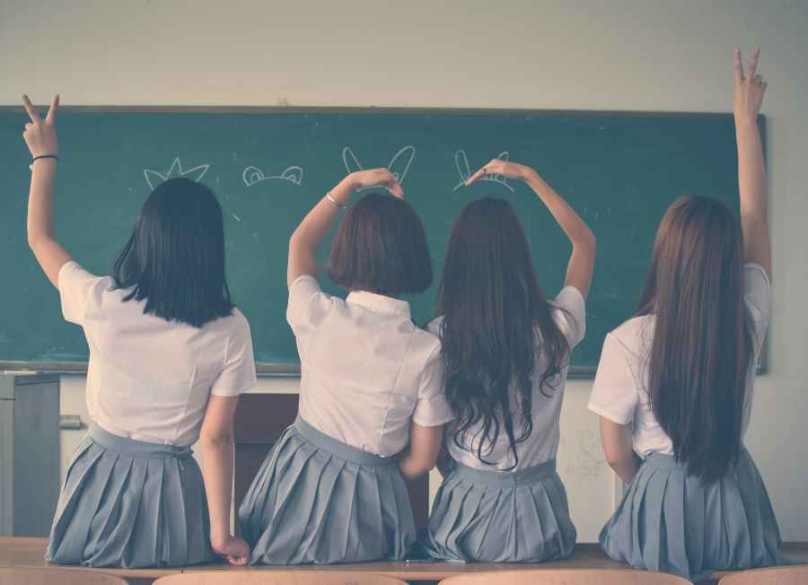 photo of four girls wearing school uniform doing hand signs at SpookyMrsGreen.com mindful parenting and modern pagan lifestyle blog.