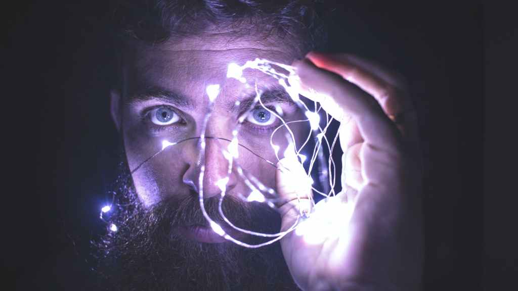 person holding string lights photo at SpookyMrsGreen.com mindful parenting and modern pagan lifestyle blog.