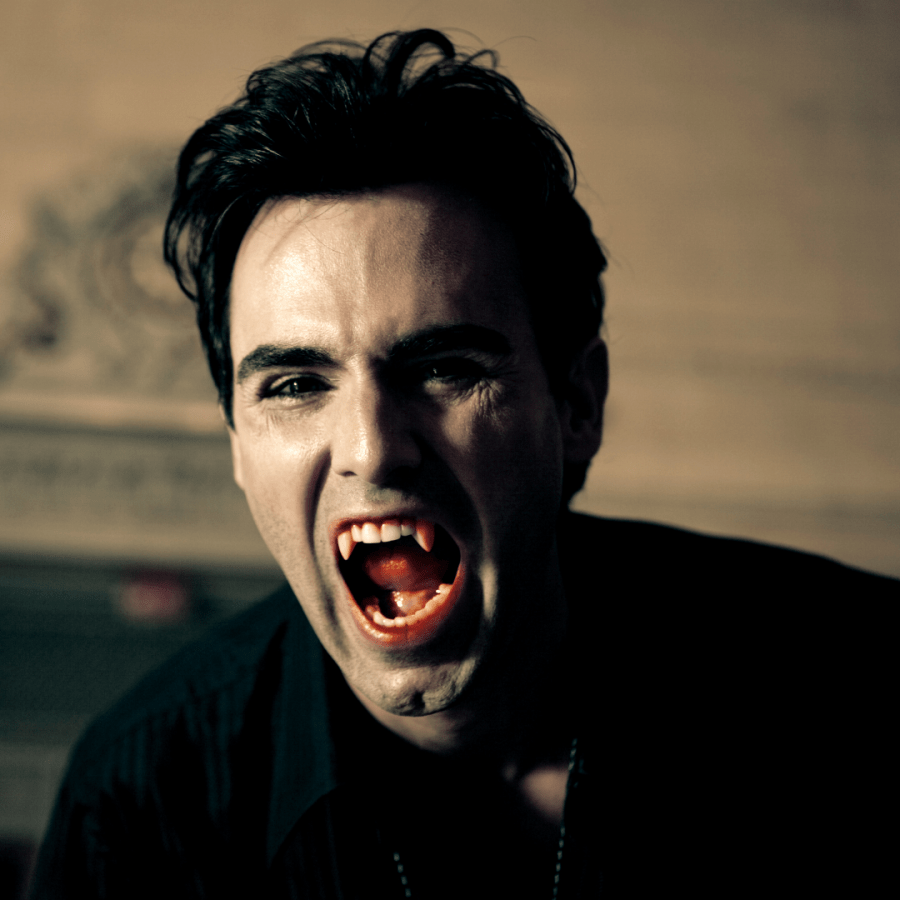 Image of a vampire with blood on his fangs. Catherine Green Vampire writer of fantasy books for adults, werewolf fiction and LGBT fantasy books. Polyamory rules in my world! SpookyMrsGreen.com mindful parenting and modern pagan lifestyle blog.