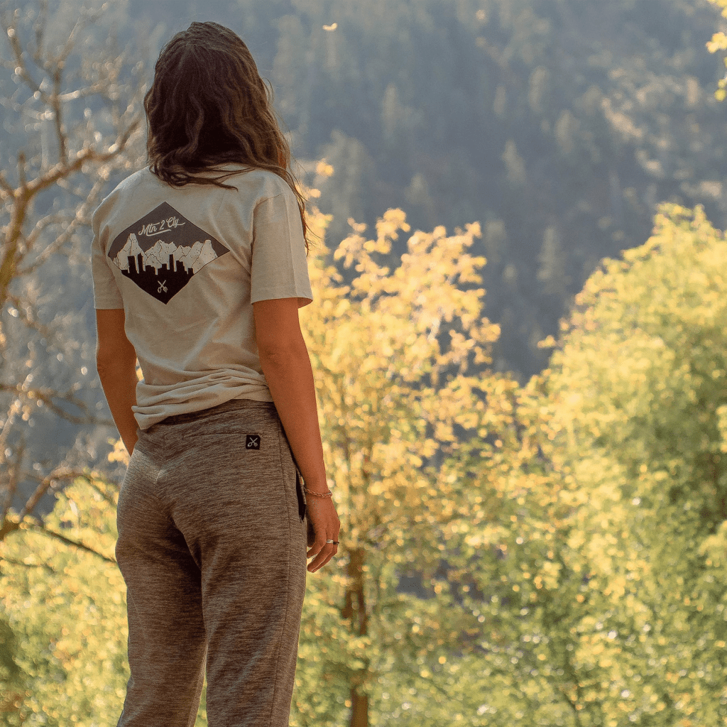 A woman wearing Coalatree Evolution Joggers standing in a forest looking at trees. Coalatree Evolution Joggers affiliated with SpookyMrsGreen.com mindful parenting and modern pagan lifestyle blog.