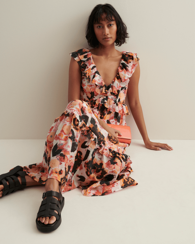 Woman wearing orange and black floral dress and black sandals. M&S Summer Fashion. Affiliated with SpookyMrsGreen.com pagan lifestyle blog.