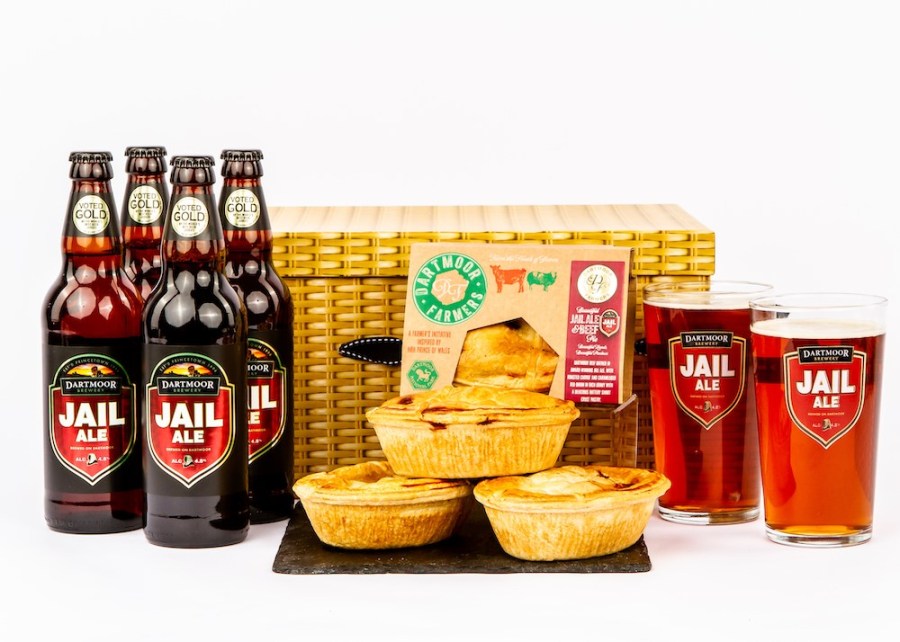 Photo of a wicker hamper, bottles of ale, meat pies and glass of beer. Father's Day Gifts for Foodies at Devon Hampers