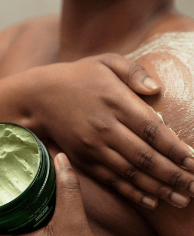Image of a person in the shower using The Body Shop Avocado Body Scrub affiliated with SpookyMrsGreen.com pagan lifestyle blog.