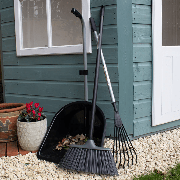 Image of Tidee Garden Companion Set Black Edition garden tools leaning against an outbuilding. Red Gorilla equine, agricultural, gardening and building products affiliated with SpookyMrsGreen.com mindful parenting and modern pagan lifestyle blog.