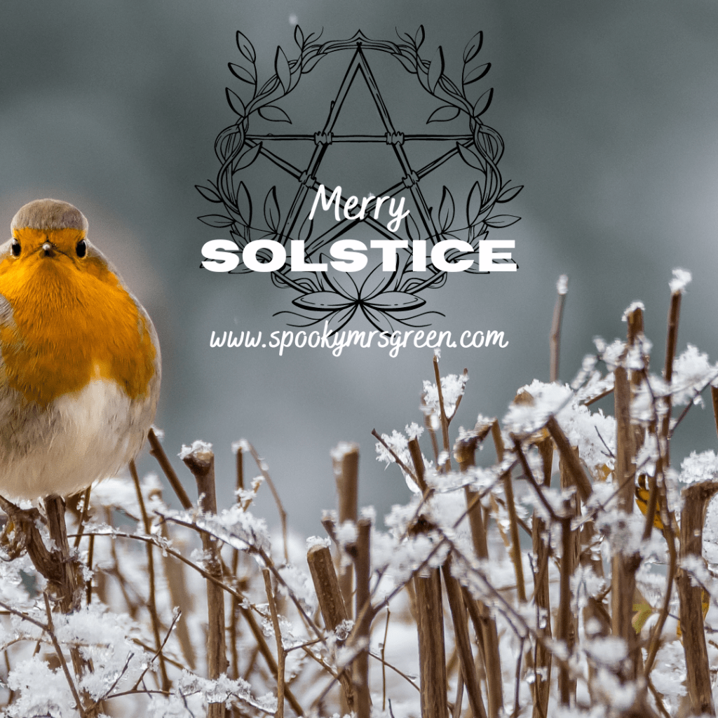 Image of a robin sitting on snow covered branches with a pentagram image above. Text reads, “Merry Solstice www.spookymrsgreen.com.” Winter Solstice celebration at SpookyMrsGreen.com mindful parenting and modern pagan lifestyle blog.