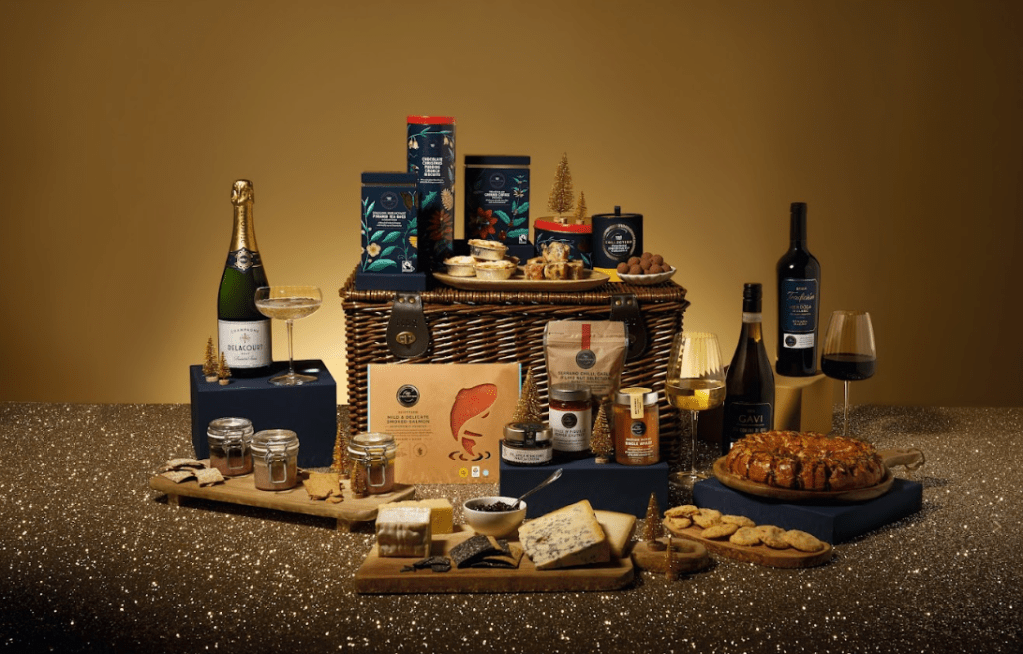 Image of a luxury food hamper with bottles of wine, bottles of champagne, luxury biscuits, luxury chocolates, luxury snacks, luxury food selection. M&S hampers from Marks and Spencer affiliated with SpookyMrsGreen.com mindful parenting and modern pagan lifestyle blog.