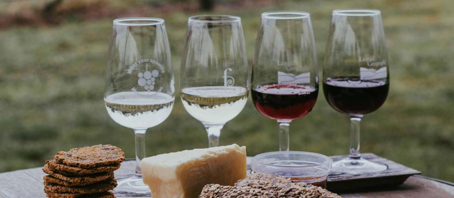 Image of cheese and biscuits and luxury wine glasses with white wine and red wine from Grapey affiliated with SpookyMrsGreen.com mindful parenting and modern pagan lifestyle blog.