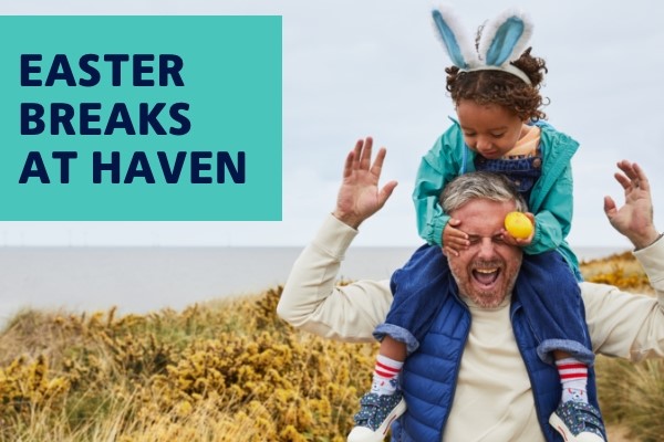 Image of a man with a child sitting on his shoulders wearing bunny ears and having fun. Text reads, “Easter Breaks at Haven.” Haven Holidays affiliated with SpookyMrsGreen.com mindful parenting and modern pagan lifestyle blog.