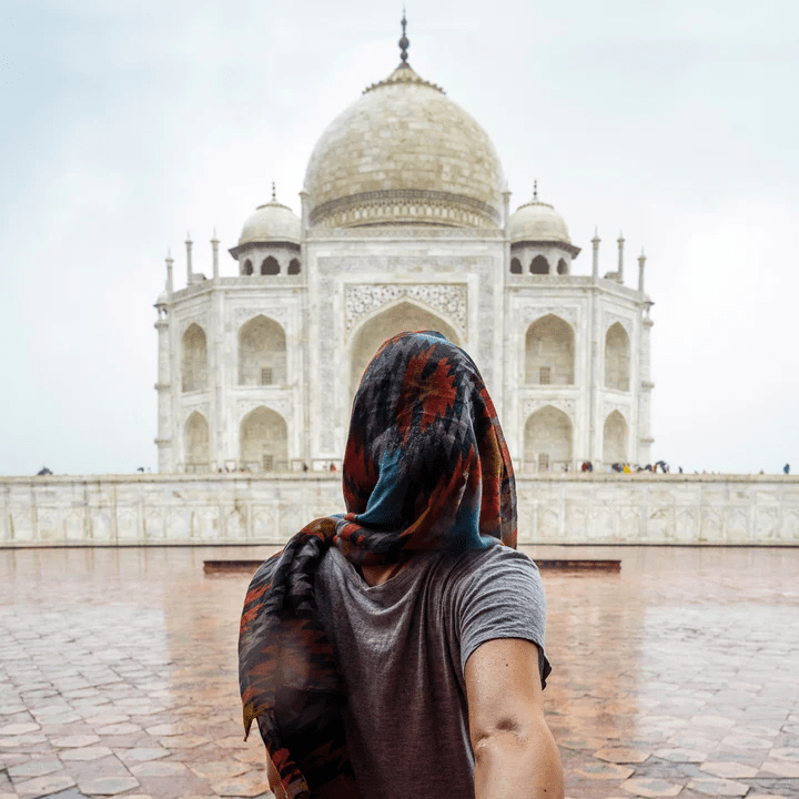 Image of a woman facing a temple in India. Yoga Retreat in India with Complete Unity Yoga affiliated with LGBT fantasy book writer Catherine Green at SpookyMrsGreen mindful parenting and modern pagan lifestyle blog.