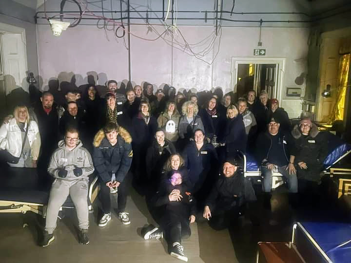 Image of ghost hunters at Bron y Garth Hospital in North Wales. Image of LGBT fantasy book writer Catherine Green at Bron y Garth Hospital overnight ghost hunt. Image of a haunted hospital ward at Bron y Garth hospital Ffestiniog Union Workhouse and former NHS hospital with Haunted Houses events with SpookyMrsGreen.com mindful parenting and modern pagan lifestyle blog.