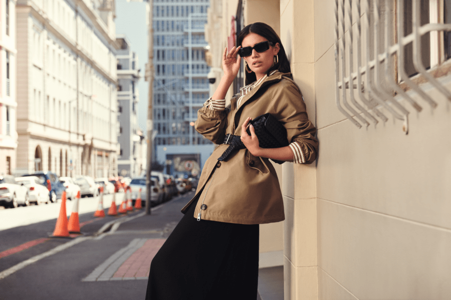 Image of a woman leaning against a tall, old building in a city centre and looking glamorous. M&S Spring Style affiliated with SpookyMrsGreen.com mindful parenting and modern pagan lifestyle blog.