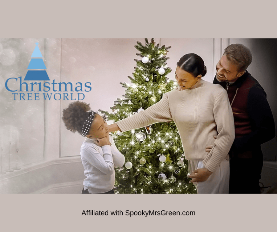 Text reads, "Christmas Tree World." Cosy image of a Christmas tree with warm lights and a young family standing around the tree smiling and having fun together. Christmas Tree World affiliated with SpookyMrsGreen.com mindful parenting and modern pagan lifestyle blog.