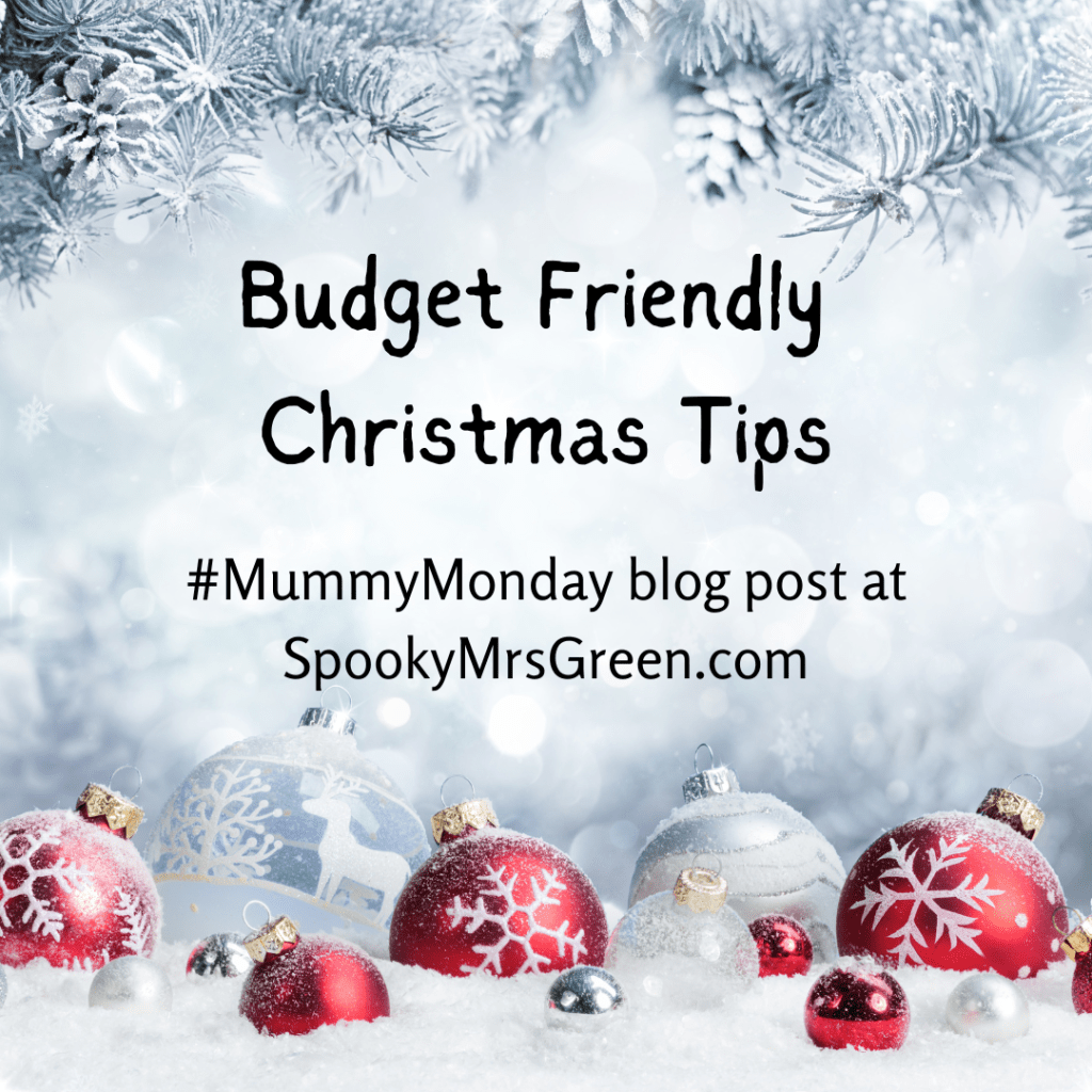 Pretty festive image of snow-covered pine trees and red and silver glitter baubles. Text reads, “Budget friendly Christmas tips #MummyMonday blog post at SpookyMrsGreen.com.”