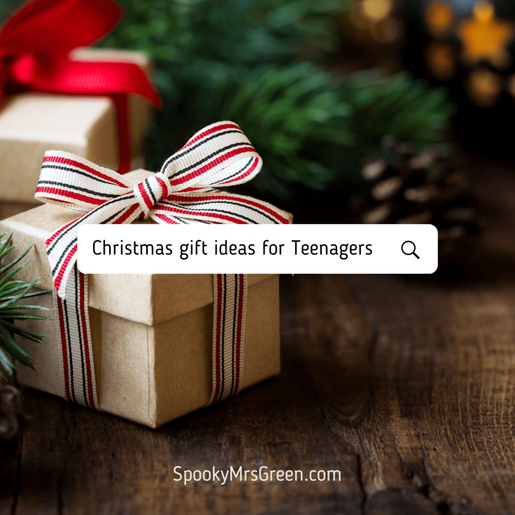 Text reads, “Christmas gift ideas for teenagers. SpookyMrsGreen.com.” Colourful image of a Christmas gift in a gift box sitting under a Christmas tree at SpookyMrsGreen spooky family lifestyle blog.