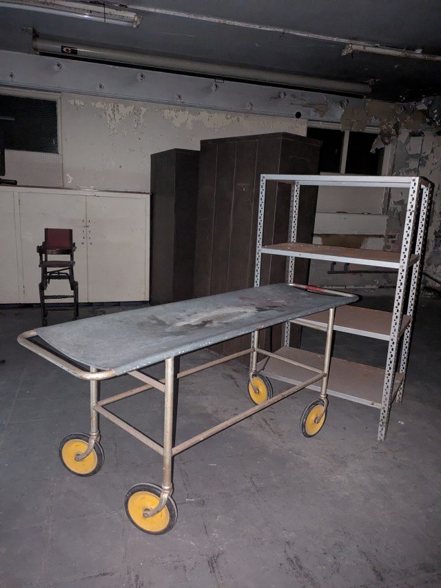Image of a derelict hospital room at Newsham Park Haunted Hospital Ghost Hunt. Haunted hospital gurney hospital trolley.