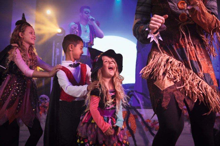 Fun spooky image of people in Halloween fancy dress costumes at a Haven holiday park for October half term. Free for All Friday pagan family pagan mom at SpookyMrsGreen.com spooky family lifestyle blog.