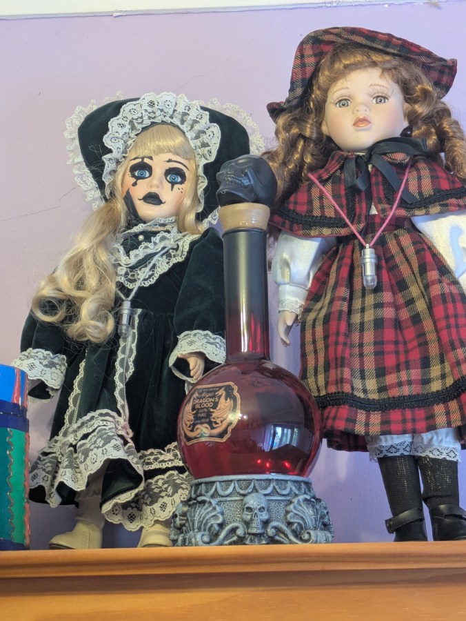 Image of haunted dolls on a shelf with lights flashing EMF activity Rempod activity paranormal investigation