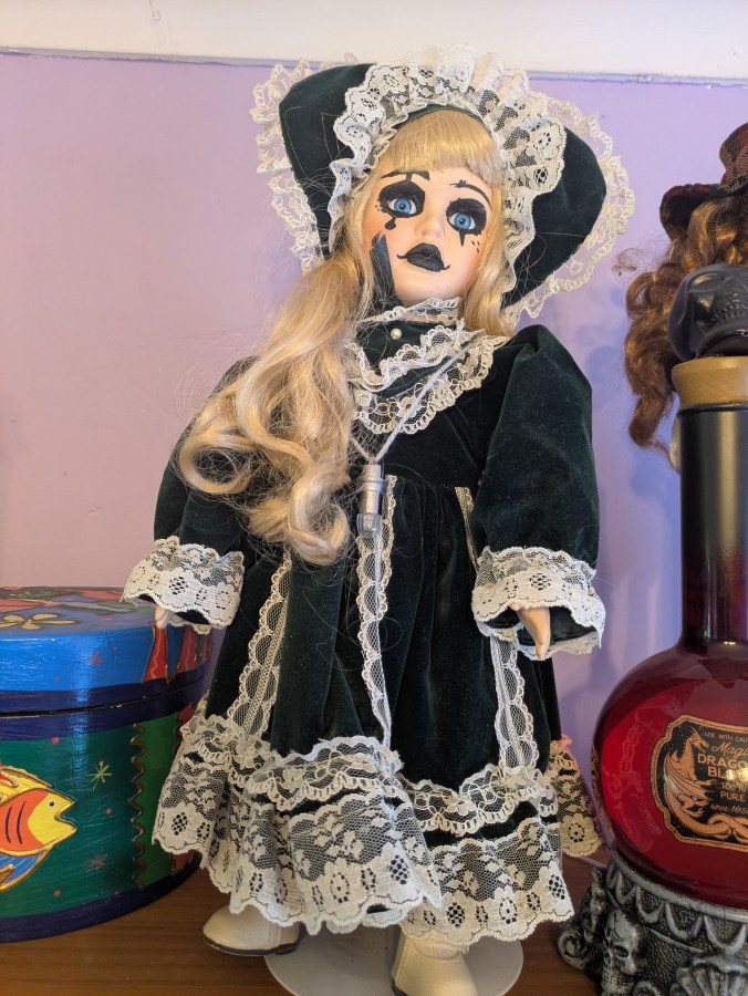 Image of haunted dolls on a shelf with lights flashing EMF activity Rempod activity paranormal investigation