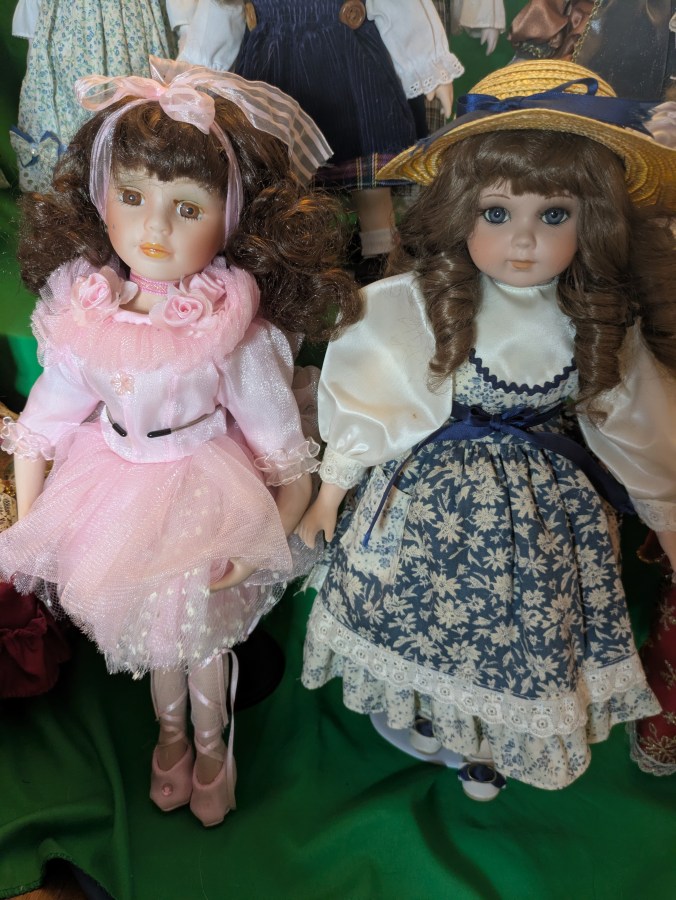 Image of haunted dolls on a shelf with lights flashing EMF activity Rempod activity paranormal investigation